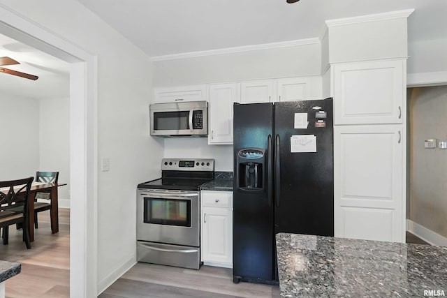850 27th St, Rock Island, IL 61201 - kitchen featuring appliances with stainless steel finishes, light wood-style floors, ceiling fan, white cabinetry, and dark stone counters