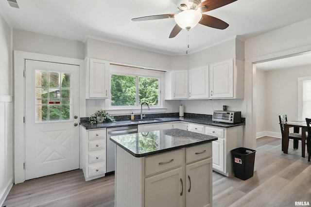 850 27th St, Rock Island, IL 61201 - kitchen featuring stainless steel dishwasher, white cabinetry, and light wood-style floors