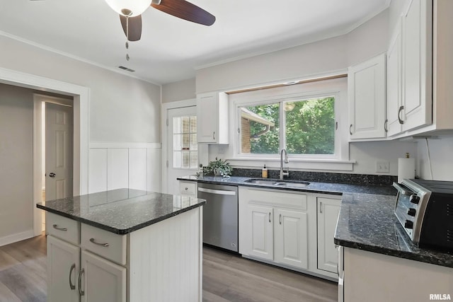 850 27th St, Rock Island, IL 61201 - kitchen featuring dishwasher, white cabinetry, light wood-type flooring, a wainscoted wall, and crown molding