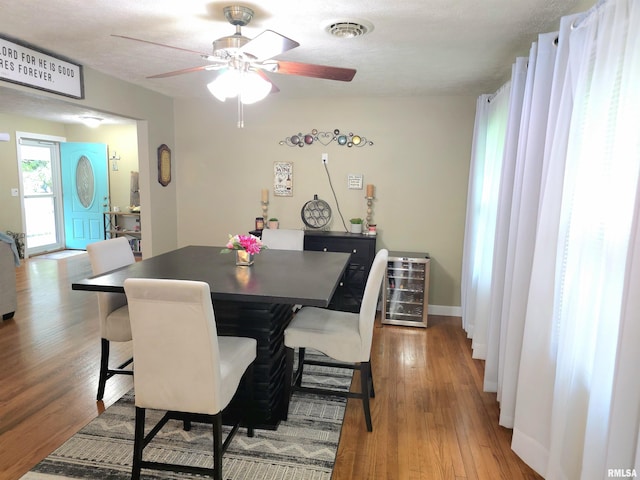 1401 Glopen Rd, Carbondale, IL 62901 - dining space featuring wine cooler, ceiling fan, and wood finished floors