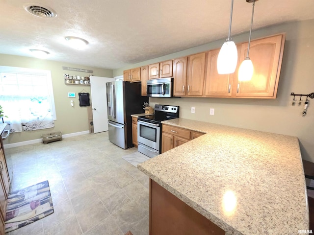 1401 Glopen Rd, Carbondale, IL 62901 - kitchen featuring appliances with stainless steel finishes, decorative light fixtures, and a peninsula