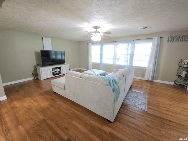 1401 Glopen Rd, Carbondale, IL 62901 - living area featuring a textured ceiling, a ceiling fan, and wood finished floors