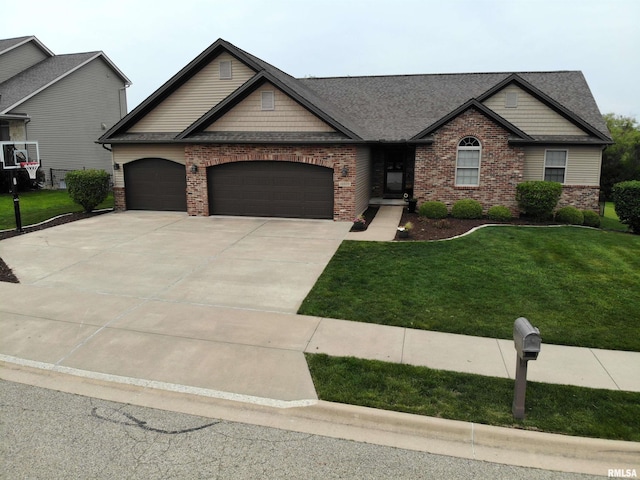 10509 N Butterfly Dr, Dunlap, IL 61525 - craftsman inspired home with brick siding, a garage, a front yard, driveway, and a shingled roof