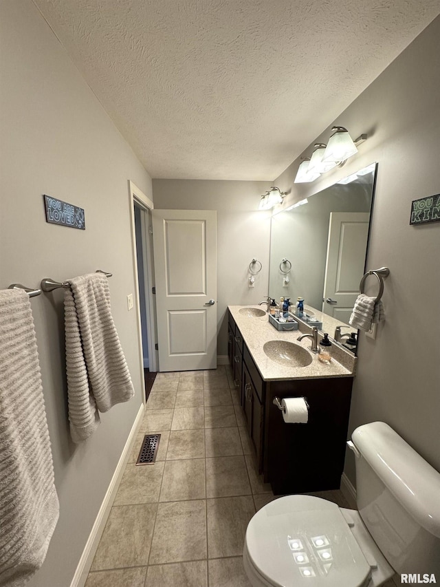 10509 N Butterfly Dr, Dunlap, IL 61525 - bathroom with double vanity, a textured ceiling, and tile patterned flooring