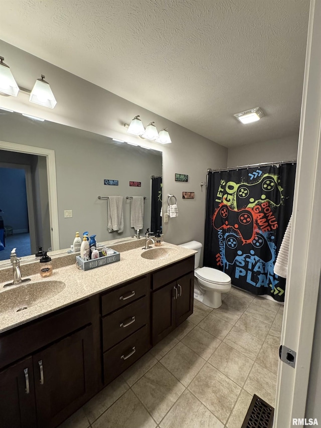 10509 N Butterfly Dr, Dunlap, IL 61525 - full bath with double vanity, tile patterned floors, and a textured ceiling