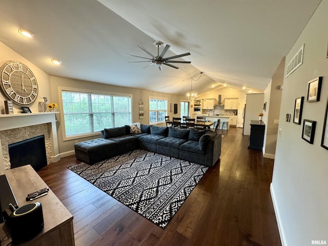 10509 N Butterfly Dr, Dunlap, IL 61525 - living room featuring lofted ceiling, a ceiling fan, dark wood-style floors, a chandelier, and a fireplace