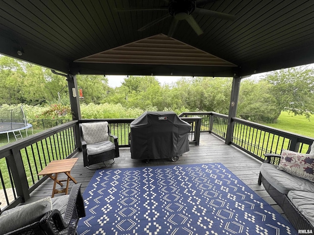 10509 N Butterfly Dr, Dunlap, IL 61525 - wooden terrace with a trampoline, a ceiling fan, a yard, area for grilling, and an outdoor hangout area