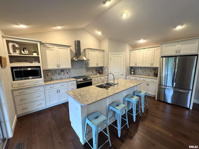 10509 N Butterfly Dr, Dunlap, IL 61525 - kitchen featuring stainless steel appliances, wall chimney exhaust hood, vaulted ceiling, a breakfast bar area, and white cabinetry