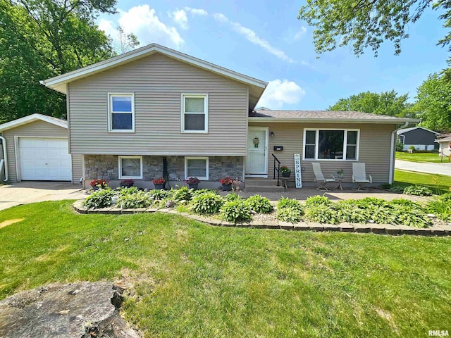 315 Colony Dr, Davenport, IA 52806 - split level home with a front yard, an outbuilding, entry steps, driveway, and a detached garage