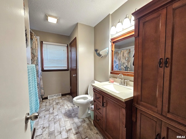 315 Colony Dr, Davenport, IA 52806 - full bathroom featuring vanity, wood finished floors, a textured ceiling, and a shower with curtain