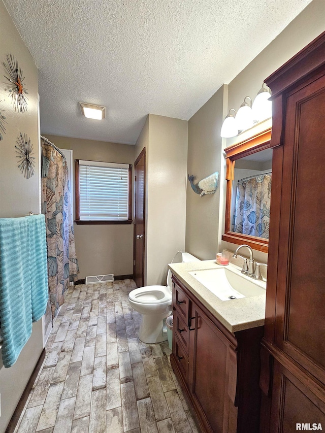 315 Colony Dr, Davenport, IA 52806 - bathroom featuring vanity, a textured ceiling, wood finished floors, and curtained shower