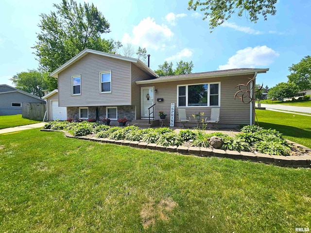 315 Colony Dr, Davenport, IA 52806 - split level home with a front yard, a garage, and stone siding