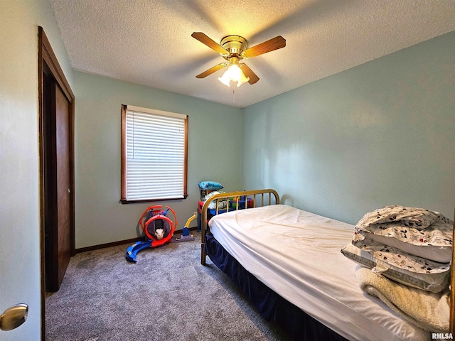 315 Colony Dr, Davenport, IA 52806 - carpeted bedroom featuring a ceiling fan, a textured ceiling, and a closet