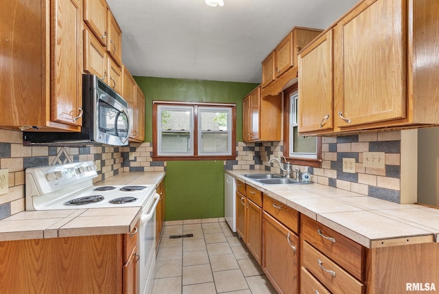 204 E Main St, Joy, IL 61260 - kitchen with white appliances, decorative backsplash, light tile patterned floors, and tile counters