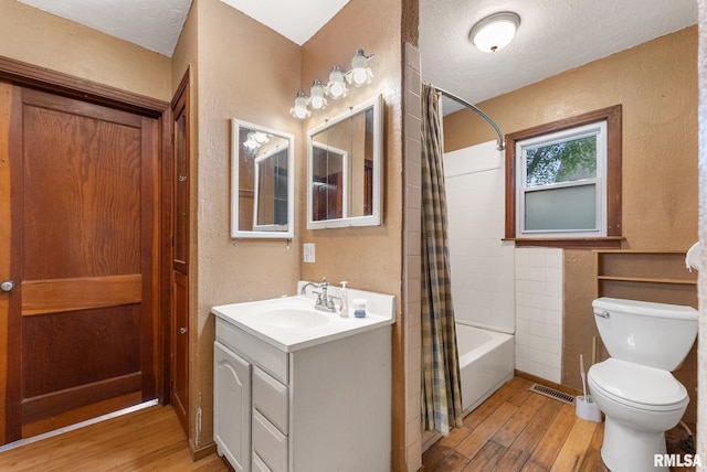 204 E Main St, Joy, IL 61260 - bathroom with hardwood / wood-style flooring, a textured wall, vanity, and shower / bath combo with shower curtain