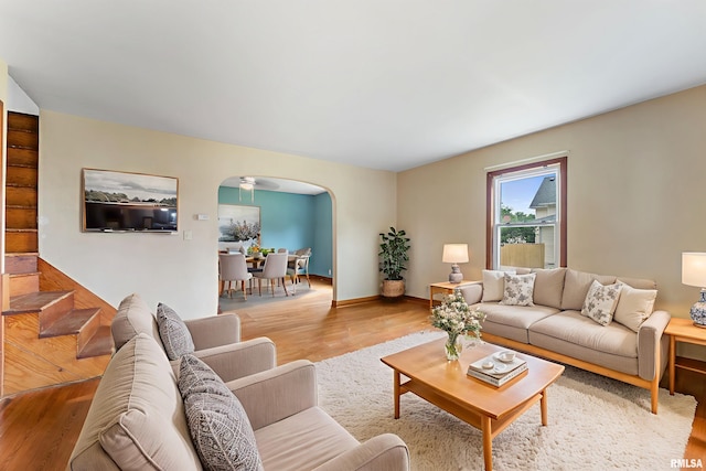 204 E Main St, Joy, IL 61260 - living area with arched walkways, wood finished floors, and stairway