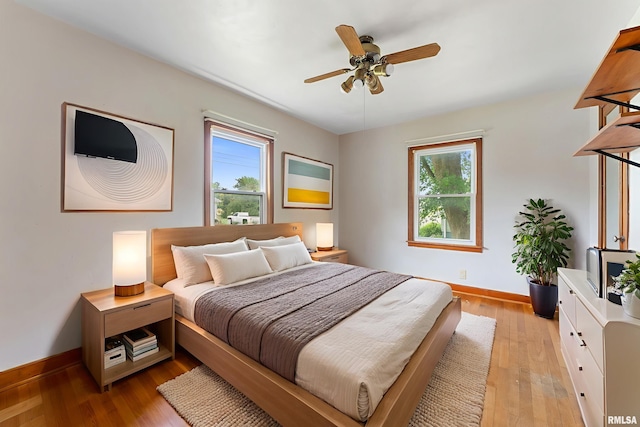 204 E Main St, Joy, IL 61260 - bedroom featuring multiple windows, light wood-style flooring, and ceiling fan