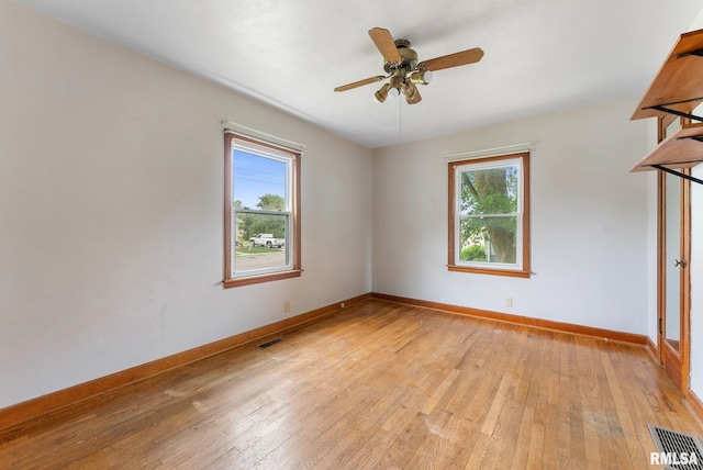 204 E Main St, Joy, IL 61260 - empty room featuring healthy amount of natural light, light wood-style floors, and ceiling fan