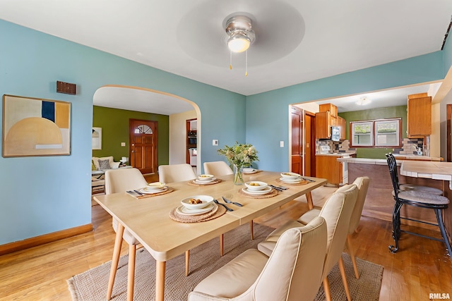 204 E Main St, Joy, IL 61260 - dining room featuring arched walkways, light wood-type flooring, and ceiling fan