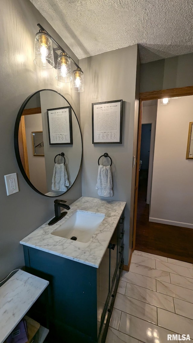1316 2nd St, Camanche, IA 52730 - bathroom featuring a textured ceiling and vanity