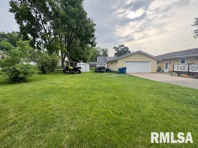 1316 2nd St, Camanche, IA 52730 - view of green lawn with concrete driveway and a garage