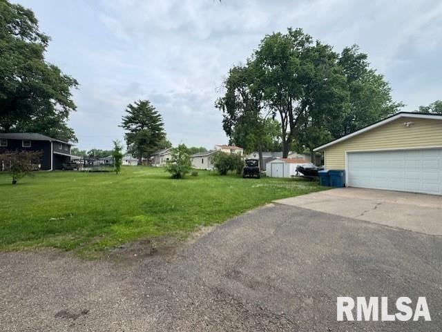 1316 2nd St, Camanche, IA 52730 - view of green lawn featuring a garage and a shed