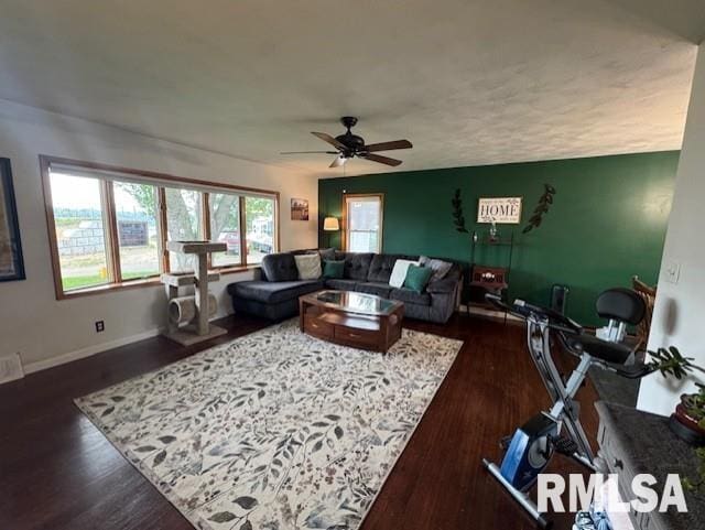 1316 2nd St, Camanche, IA 52730 - living room featuring ceiling fan and dark wood-style flooring