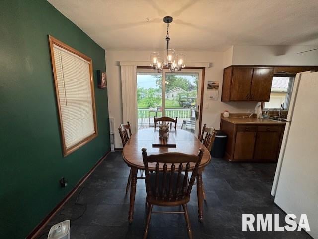 1316 2nd St, Camanche, IA 52730 - dining space featuring a chandelier and healthy amount of natural light