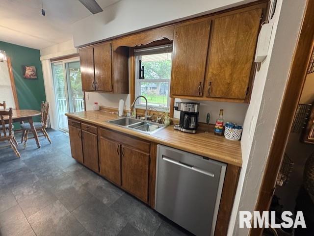 1316 2nd St, Camanche, IA 52730 - kitchen with dishwasher, light countertops, and brown cabinetry