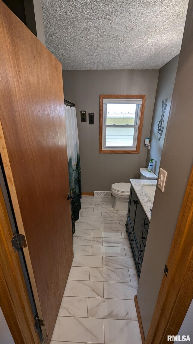 1316 2nd St, Camanche, IA 52730 - bathroom with vanity, marble finish flooring, a textured ceiling, and a shower with curtain