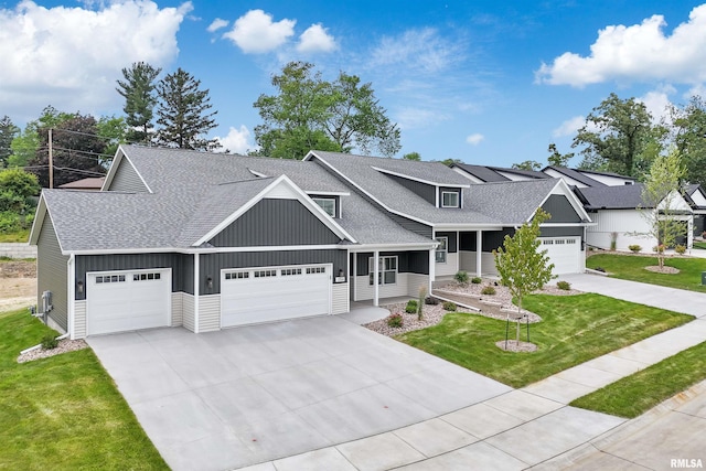 1354 Heights Ct, Bettendorf, IA 52722 - view of front facade with a shingled roof, concrete driveway, board and batten siding, and a front yard
