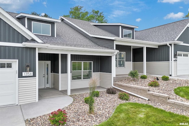 1354 Heights Ct, Bettendorf, IA 52722 - doorway to property with a shingled roof, an attached garage, and a porch