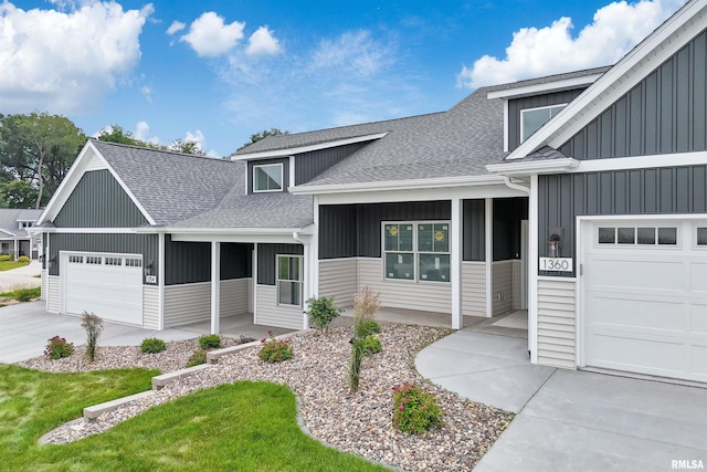 1354 Heights Ct, Bettendorf, IA 52722 - view of front facade featuring a shingled roof, a garage, board and batten siding, and driveway