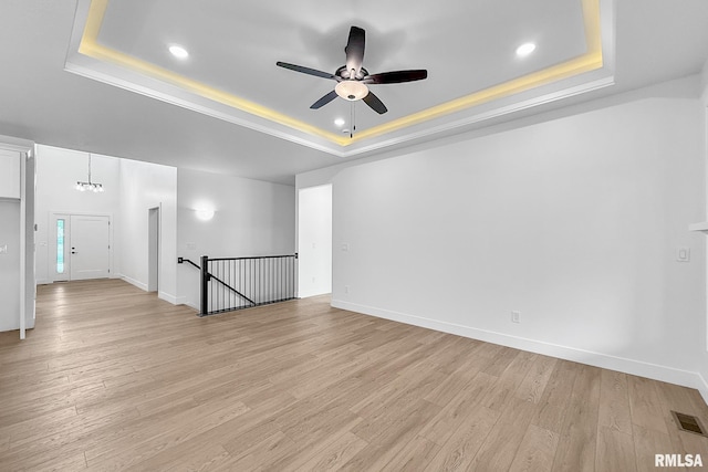 1354 Heights Ct, Bettendorf, IA 52722 - unfurnished room featuring a raised ceiling, a ceiling fan, light wood-type flooring, and recessed lighting