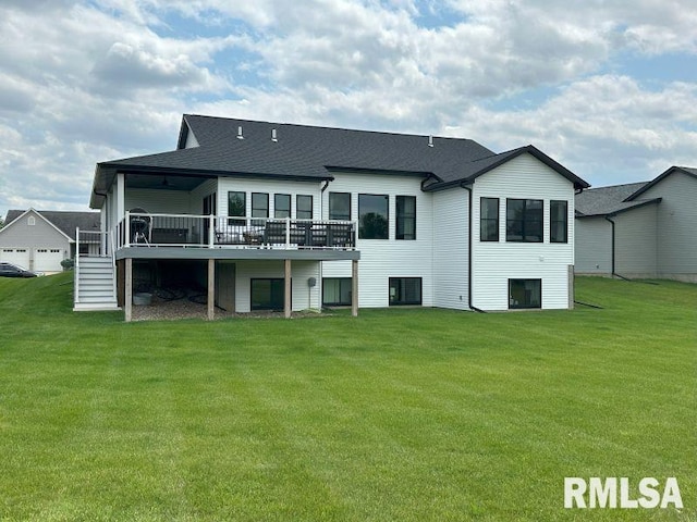 1722 17th St, De Witt, IA 52742 - back of house featuring a deck, a lawn, stairway, and a shingled roof