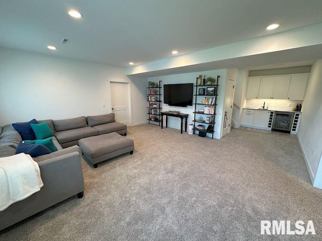 1722 17th St, De Witt, IA 52742 - living room featuring recessed lighting, light colored carpet, bar, and beverage cooler