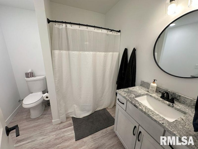 1722 17th St, De Witt, IA 52742 - full bath featuring wood finished floors, vanity, and curtained shower