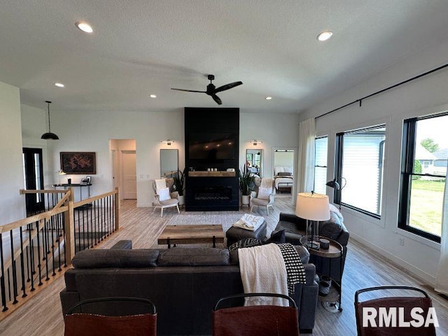 1722 17th St, De Witt, IA 52742 - living area featuring light wood-type flooring, a ceiling fan, recessed lighting, and a fireplace