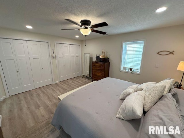 1144 Brookview Dr, De Witt, IA 52742 - bedroom with multiple closets, light wood-type flooring, recessed lighting, a textured ceiling, and ceiling fan