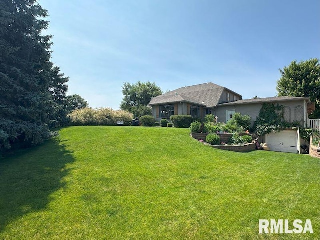1144 Brookview Dr, De Witt, IA 52742 - view of grassy yard with an attached garage