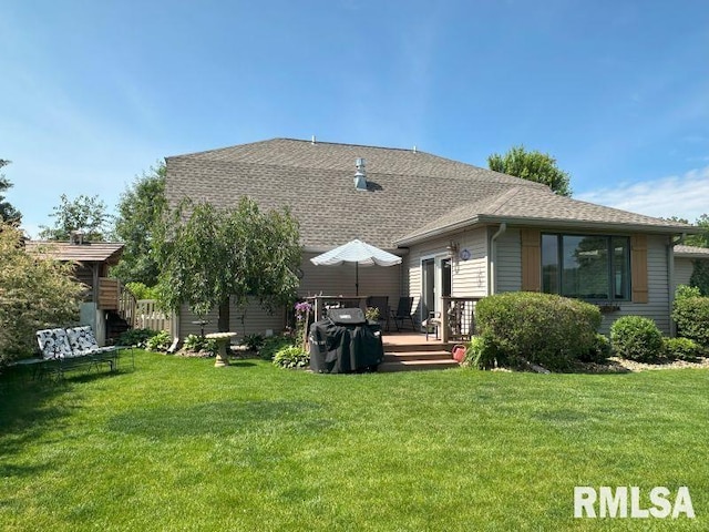 1144 Brookview Dr, De Witt, IA 52742 - rear view of house with a deck, a yard, and a shingled roof