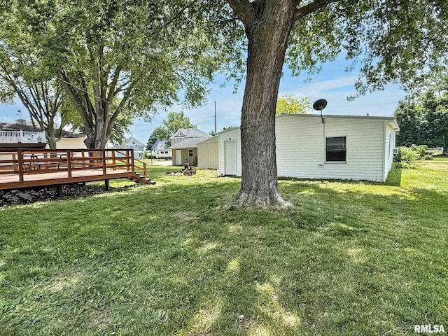 511 Fulton St, Grand Mound, IA 52751 - view of green lawn with a wooden deck
