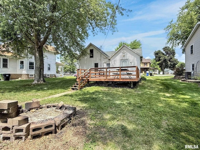 511 Fulton St, Grand Mound, IA 52751 - rear view of property with a yard and a wooden deck