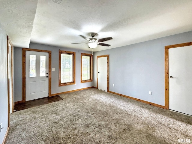 511 Fulton St, Grand Mound, IA 52751 - carpeted foyer entrance with a textured ceiling and ceiling fan