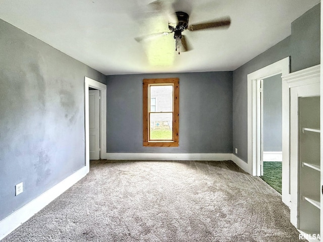 511 Fulton St, Grand Mound, IA 52751 - unfurnished bedroom with carpet and a ceiling fan