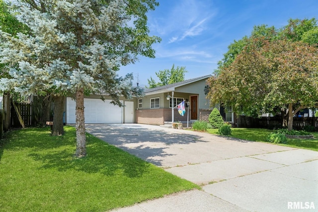 1445 Lawrence Ave, Camanche, IA 52730 - view of front facade with driveway, a garage, and brick siding