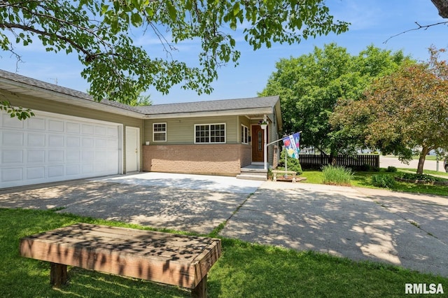 1445 Lawrence Ave, Camanche, IA 52730 - ranch-style home with concrete driveway, brick siding, and an attached garage