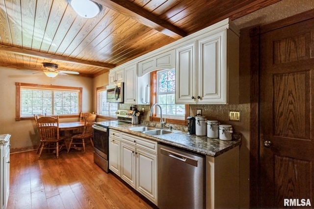 1445 Lawrence Ave, Camanche, IA 52730 - kitchen with appliances with stainless steel finishes, wooden ceiling, hardwood / wood-style floors, decorative backsplash, and a ceiling fan