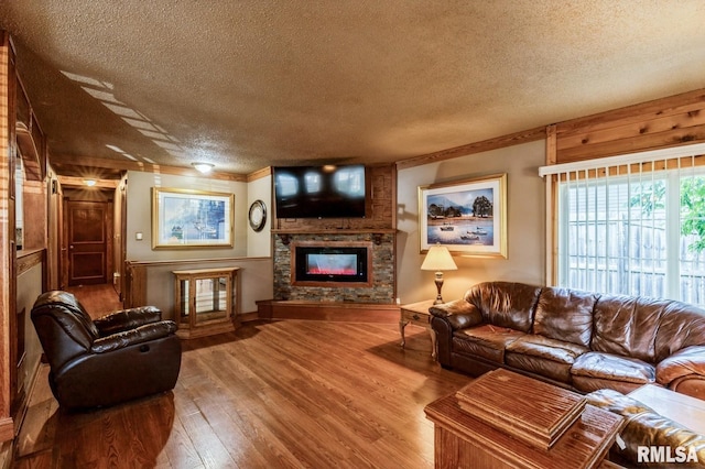 1445 Lawrence Ave, Camanche, IA 52730 - living room with a glass covered fireplace, a textured ceiling, wood finished floors, and crown molding