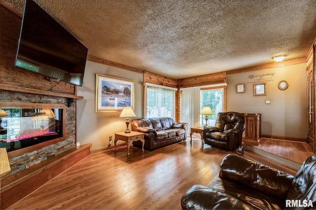 1445 Lawrence Ave, Camanche, IA 52730 - living area with hardwood / wood-style flooring, a textured ceiling, crown molding, and a multi sided fireplace